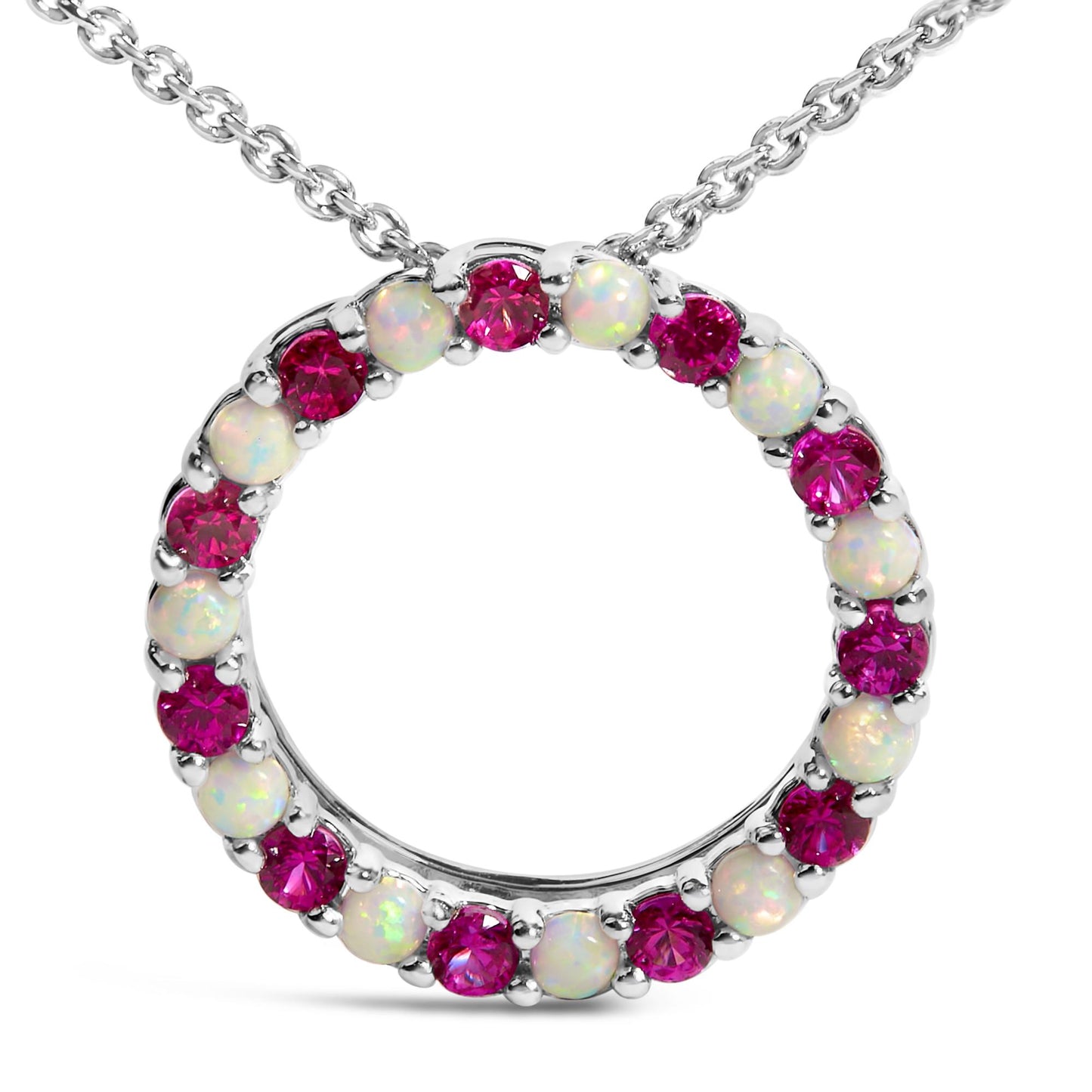 Close-up front view of a white metal circular necklace pendant set with alternating round red and white gemstones, shown on a white background.
