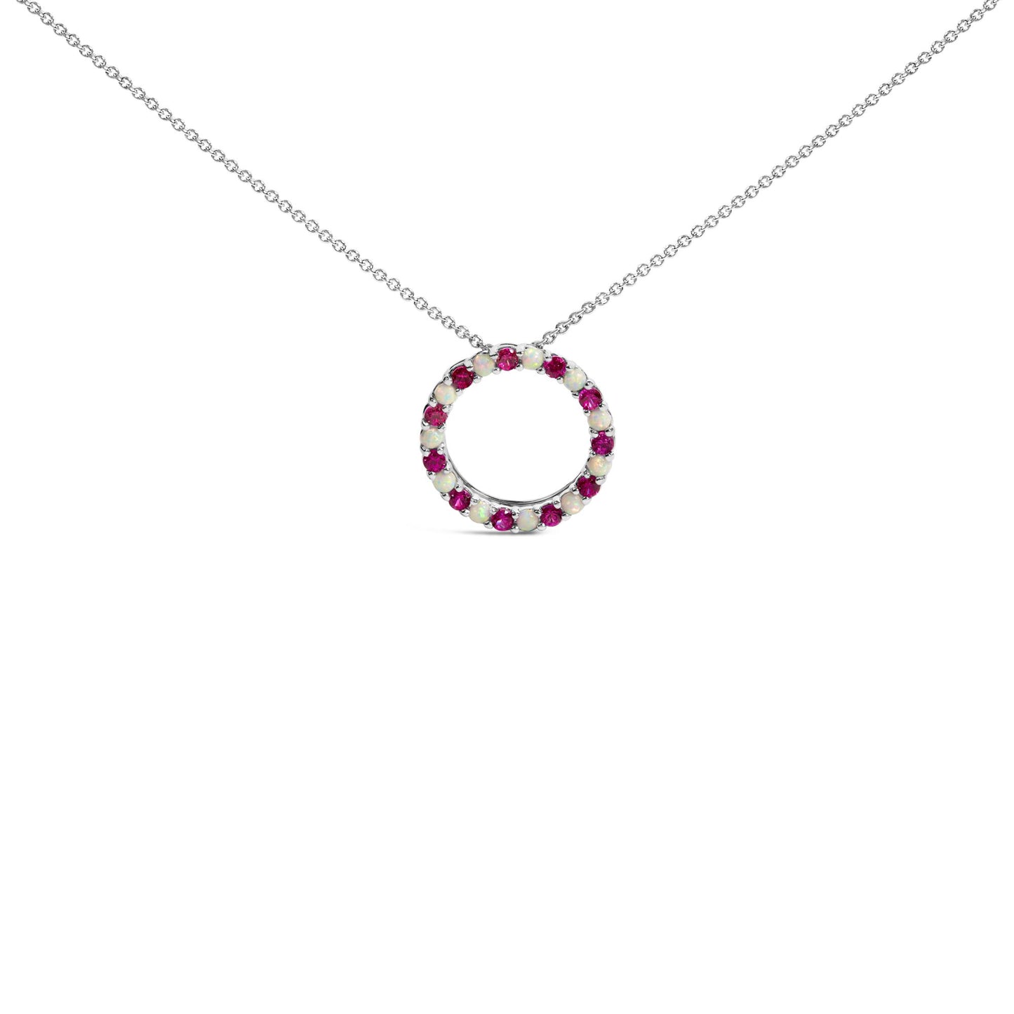 White metal necklace with a circular pendant set with alternating round red and white gemstones in prong settings, shown in a front-facing angle on a white background.
