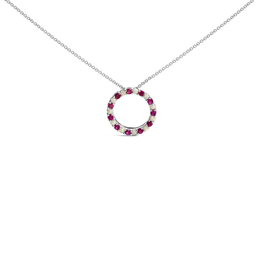 White metal necklace with a circular pendant set with alternating round red and white gemstones in prong settings, shown in a front-facing angle on a white background.