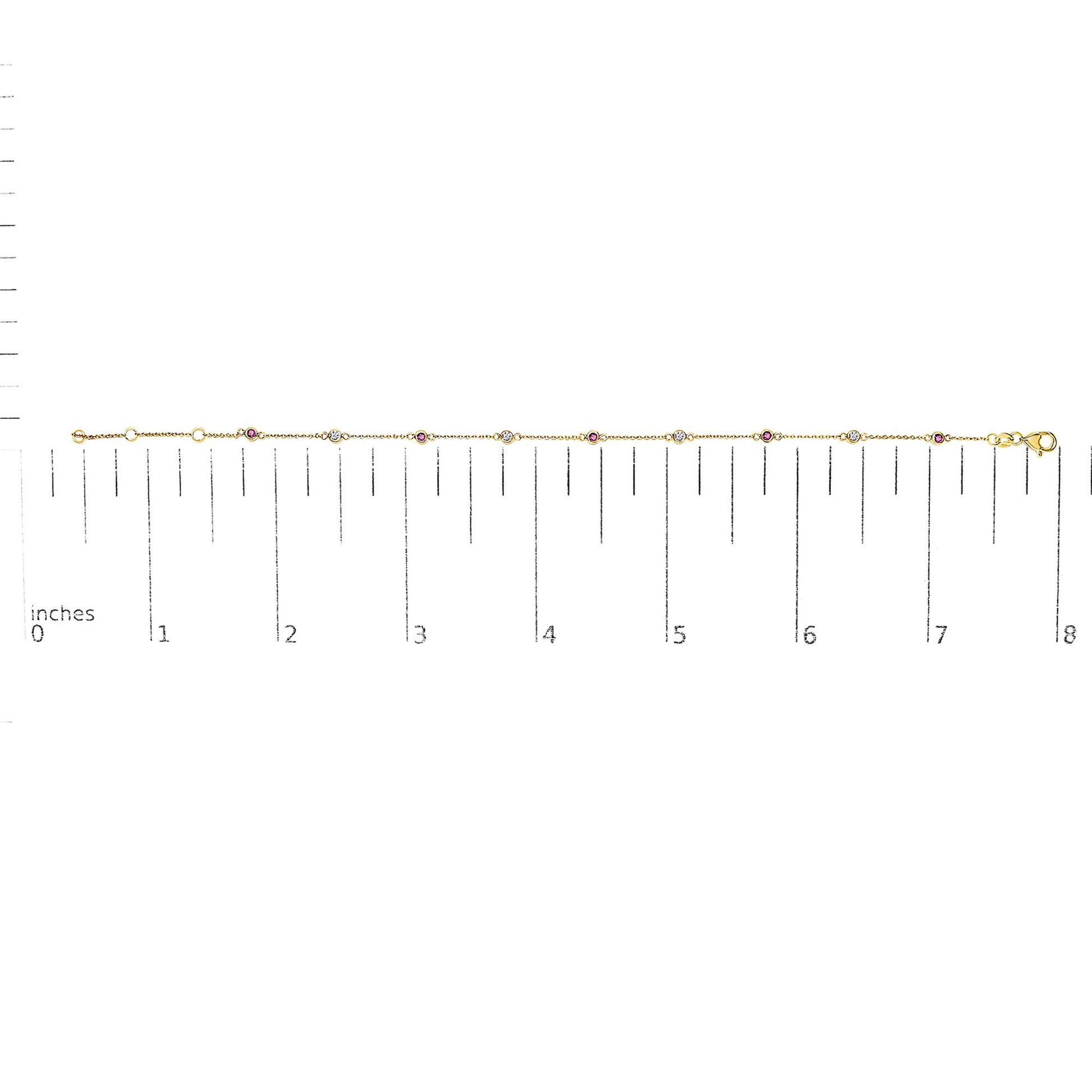 Yellow bracelet with alternating round white and red gemstones in bezel settings, displayed flat on a ruler for size reference, top-down angle.