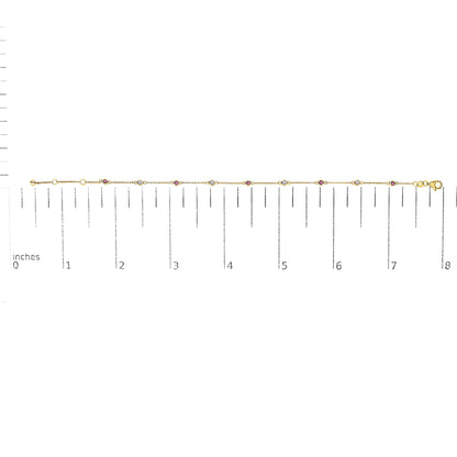 Yellow bracelet with alternating round white and red gemstones in bezel settings, displayed flat on a ruler for size reference, top-down angle.