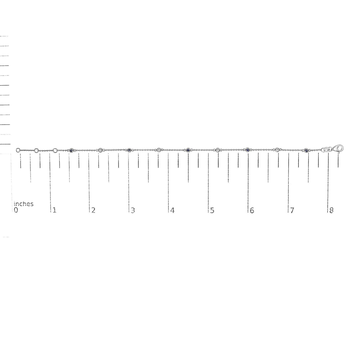 White metal bracelet with alternating round white and blue gemstones in bezel settings, laid flat on a ruler for size reference, front-facing angle.