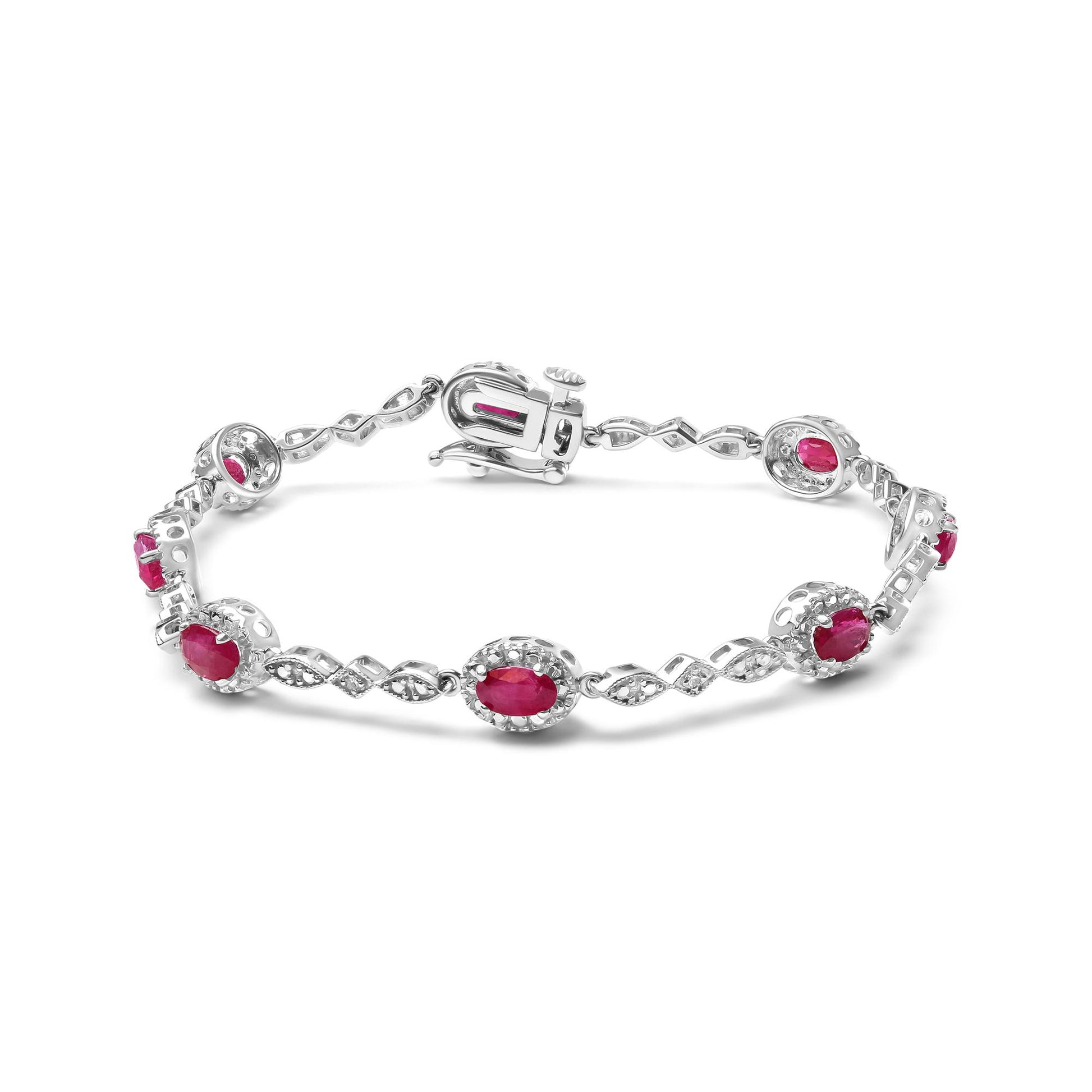 White metal bracelet with alternating oval red gemstones and decorative links with small white round gemstones, shown from a slightly elevated angle.