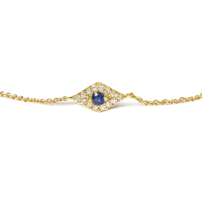 Yellow metal bracelet with a central blue gemstone surrounded by small white gemstones in a diamond-shaped setting, shown in a front-facing close-up.