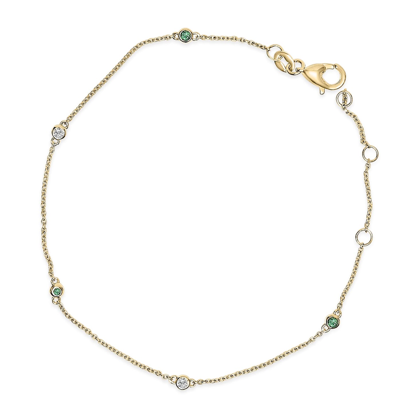 Yellow metal bracelet with round white and green gemstones in bezel settings, shown flat from above.
