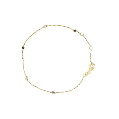 Top-down view of a delicate yellow bracelet with an alternating pattern of round red and white gemstones set in bezels on a fine chain with a lobster clasp.