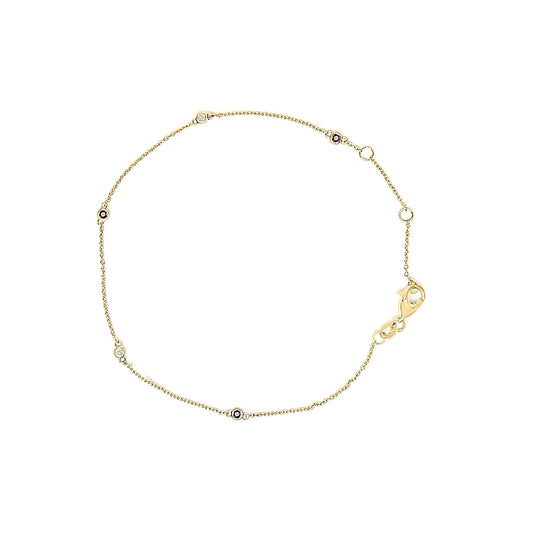 Top-down view of a delicate yellow bracelet with an alternating pattern of round red and white gemstones set in bezels on a fine chain with a lobster clasp.