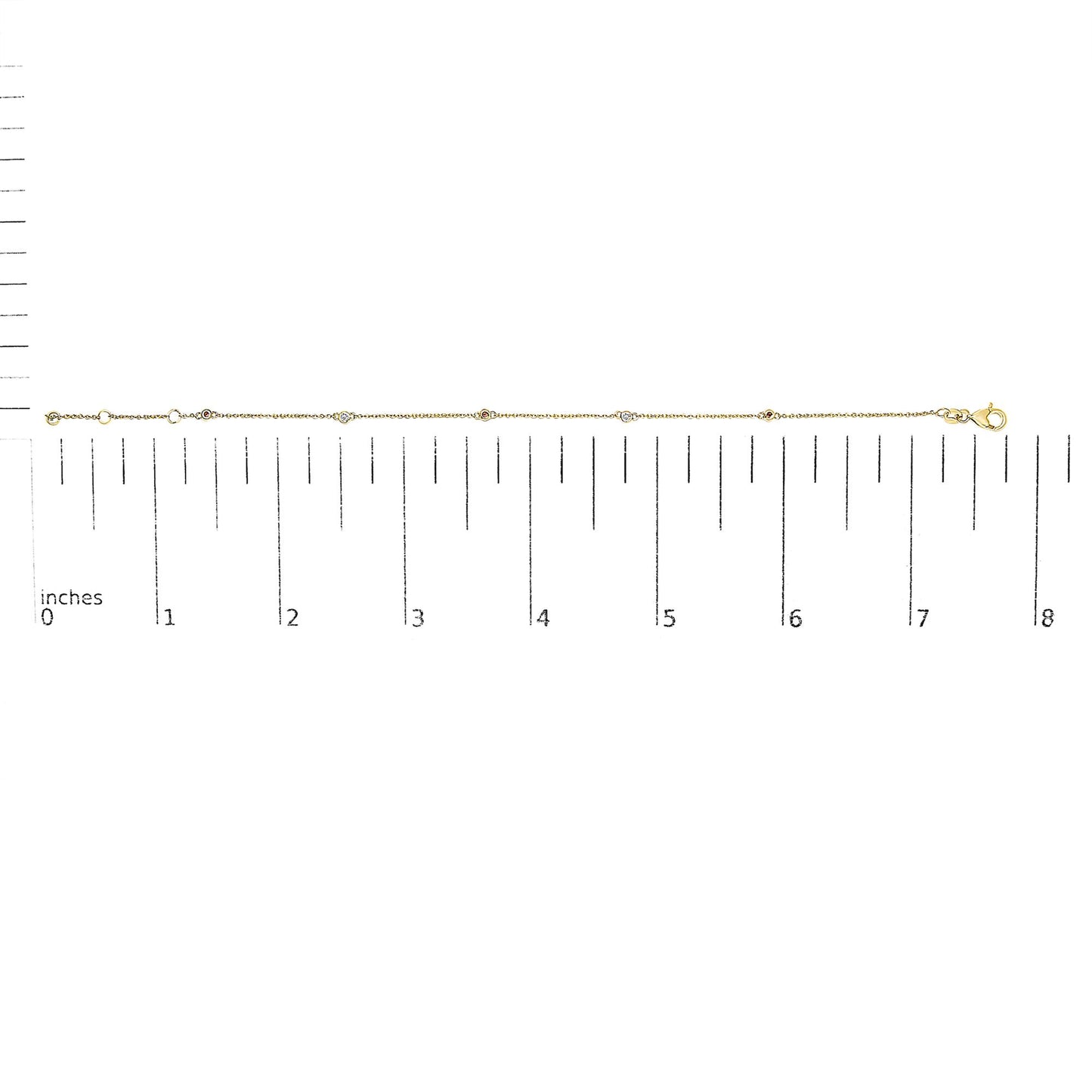 Yellow metal bracelet with alternating round white and red gemstones in bezel settings, shown horizontally on a ruler for size reference.