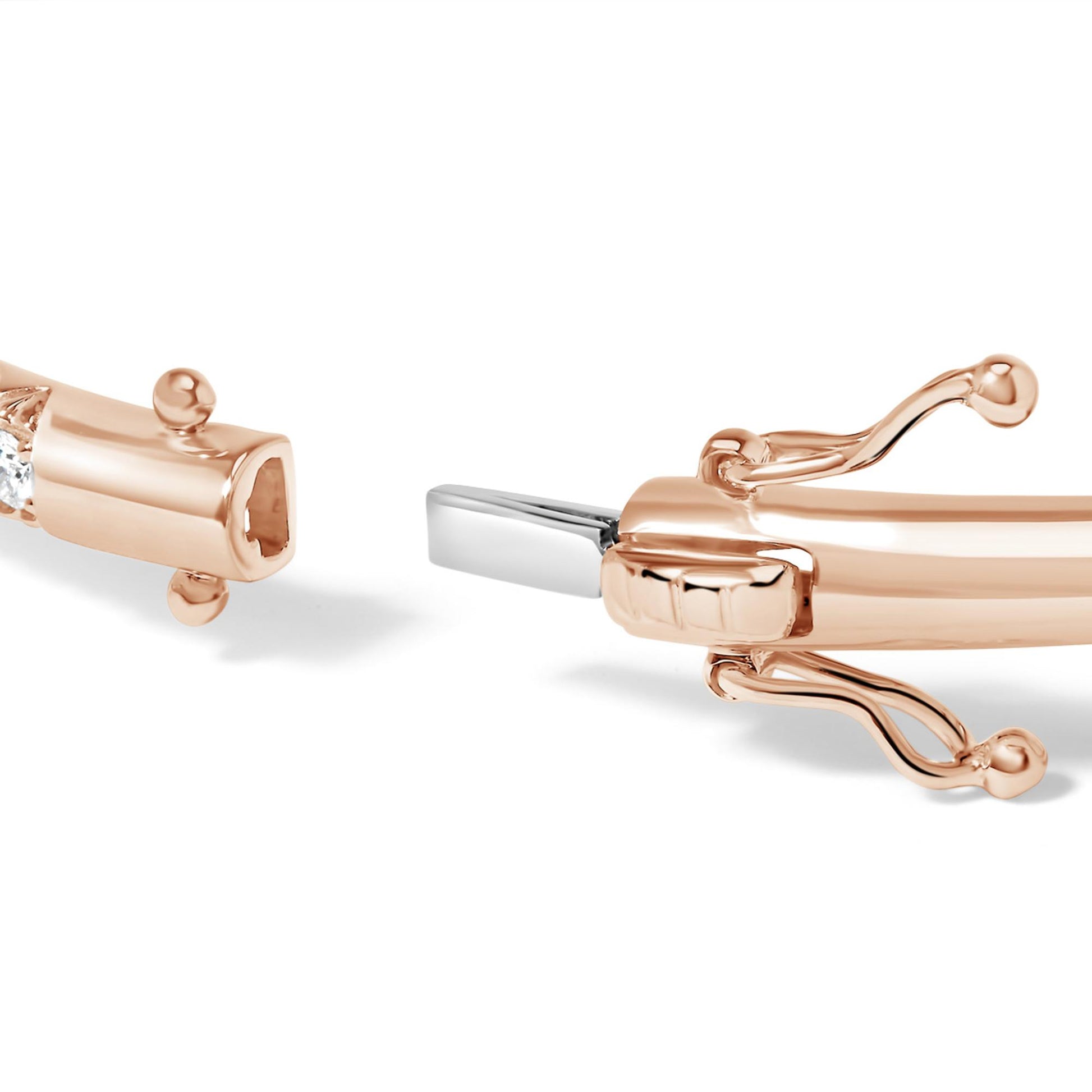 Close-up side view of rose-colored bracelet clasp with round white gemstones in pave setting.