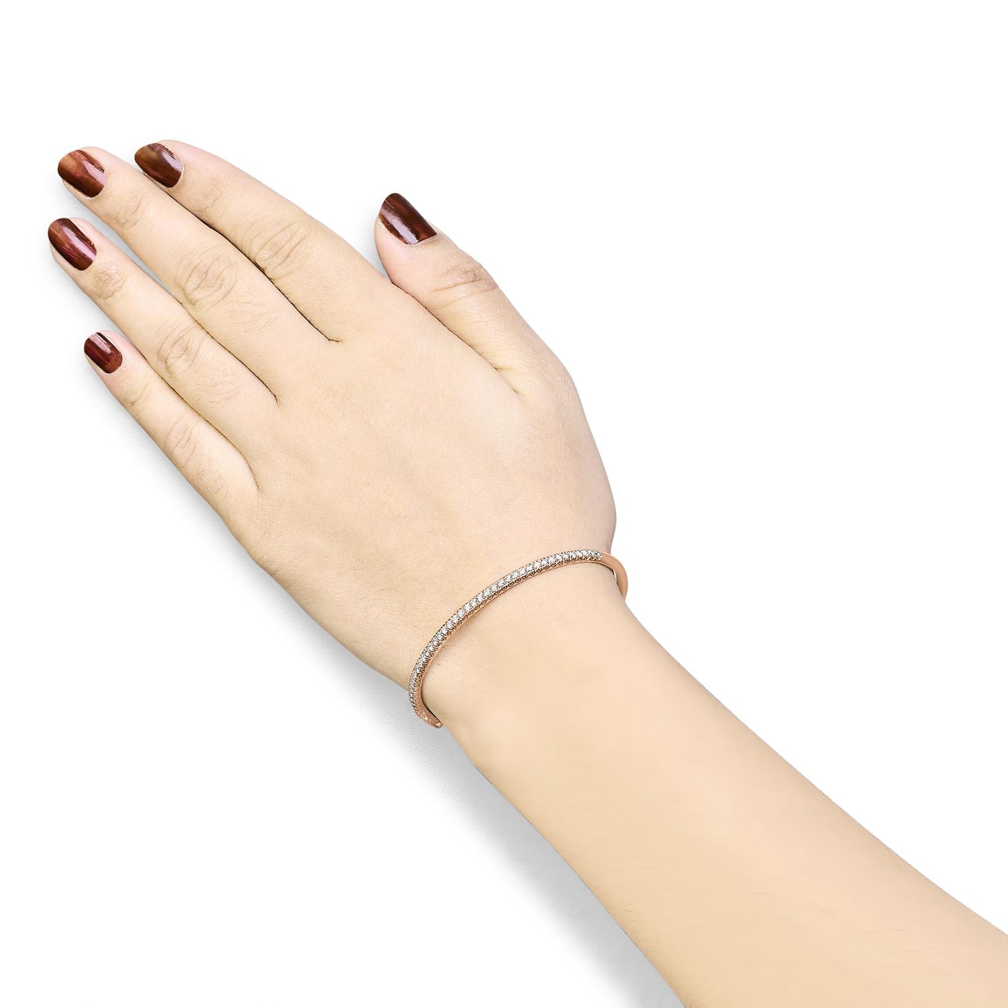 Rose metal bracelet with pave set white round gemstones, worn on a model's wrist, shot from an overhead angle.