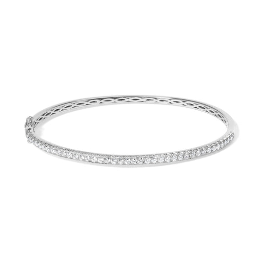 White metal bangle bracelet with a row of round white gemstones in pave setting, shown from a slightly elevated side angle.