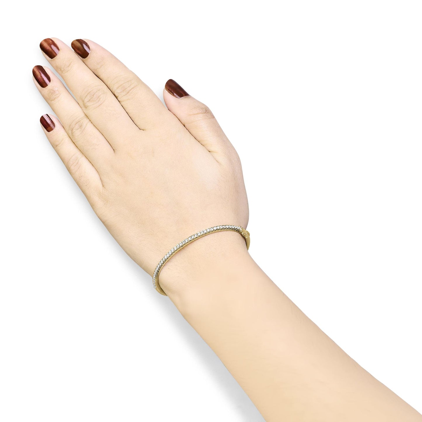 Close-up angled shot of a yellow metal bracelet with a row of small white gemstones in a pave setting, worn on a model's wrist.