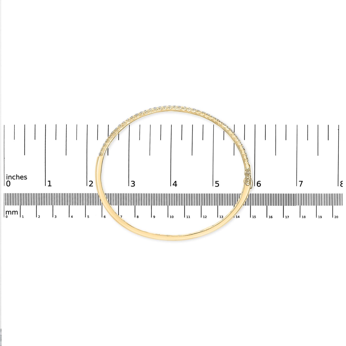 Top-down view of a yellow bracelet with a row of white round pave-set gemstones, placed on a ruler for size reference.