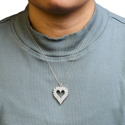White metal heart-shaped necklace pendant with prong-set round brownish gemstones, worn on a model, front view.
