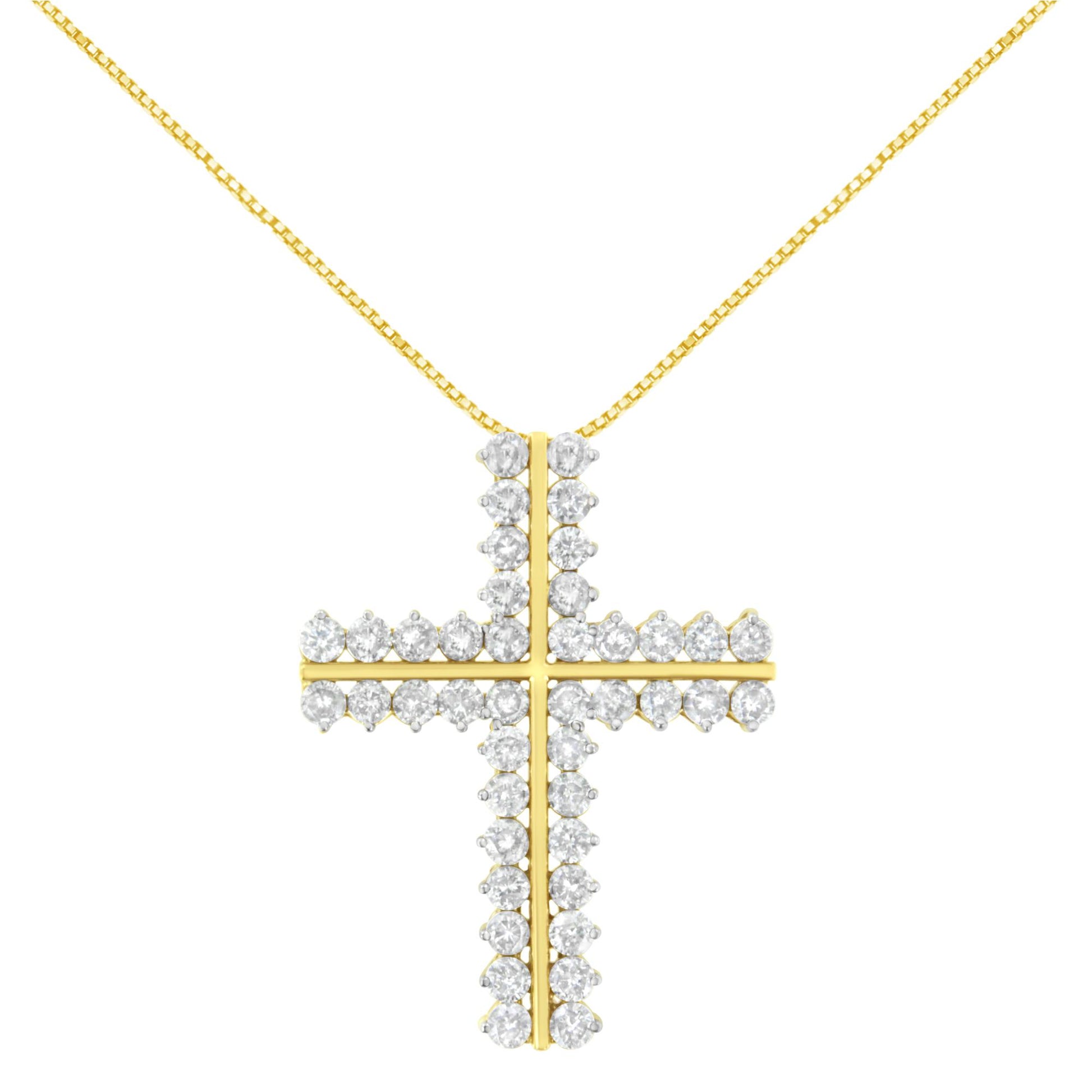 Front view of a yellow metal cross-shaped necklace pendant with round white gemstones in prong settings, suspended on a yellow chain.