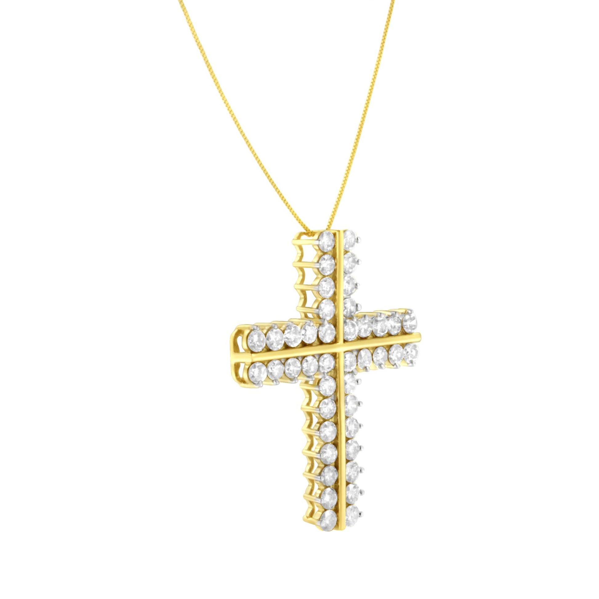 Yellow metal cross-shaped necklace pendant with round white gemstones in prong settings, shown at a slight angle from the side.
