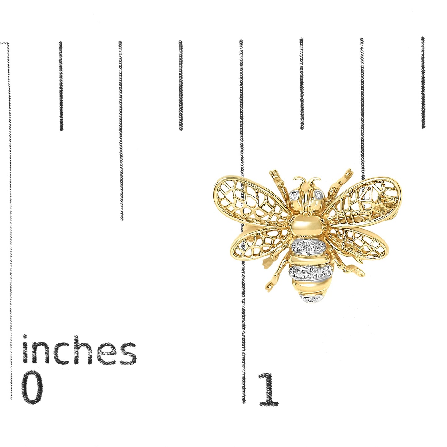Close-up front view of a yellow and white metal bee-shaped brooch with white gemstones on the eyes and body, shown on a scale background.