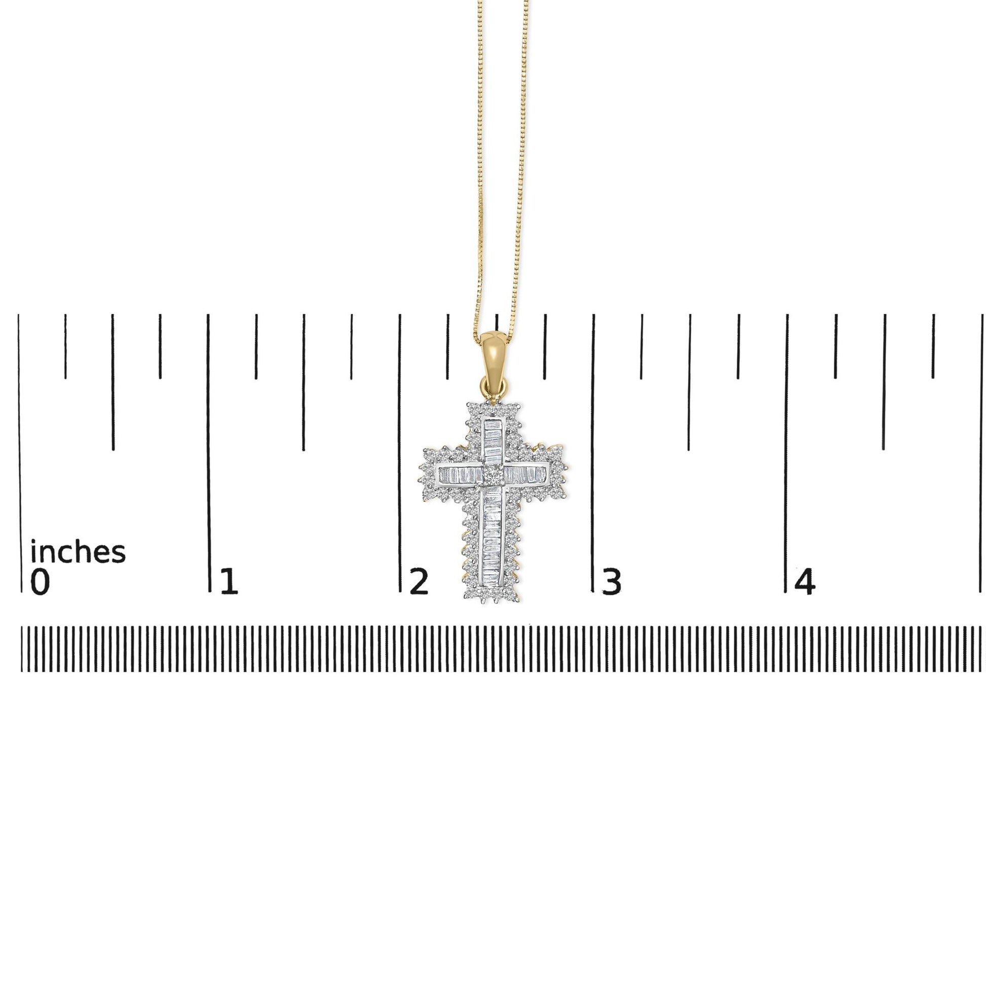 Yellow metal cross-shaped necklace with round and baguette white gemstones, shown hanging centered on a ruler for scale, front-facing angle.