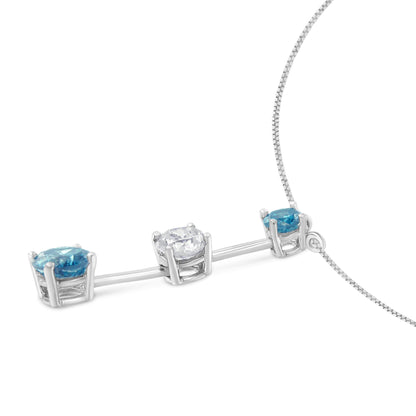 Close-up front angle of a white metal necklace with a horizontal bar featuring one white round gemstone and two blue round gemstones in prong settings.