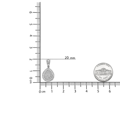 White metal teardrop-shaped necklace pendant with round and baguette white gemstones, shown flat on a ruler for size reference, viewed from the front.