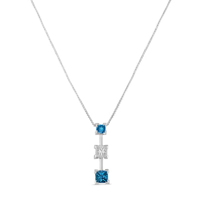 Front view of a white necklace with a vertical pendant featuring three princess-shaped prong-set gemstones, two blue and one white in the center.