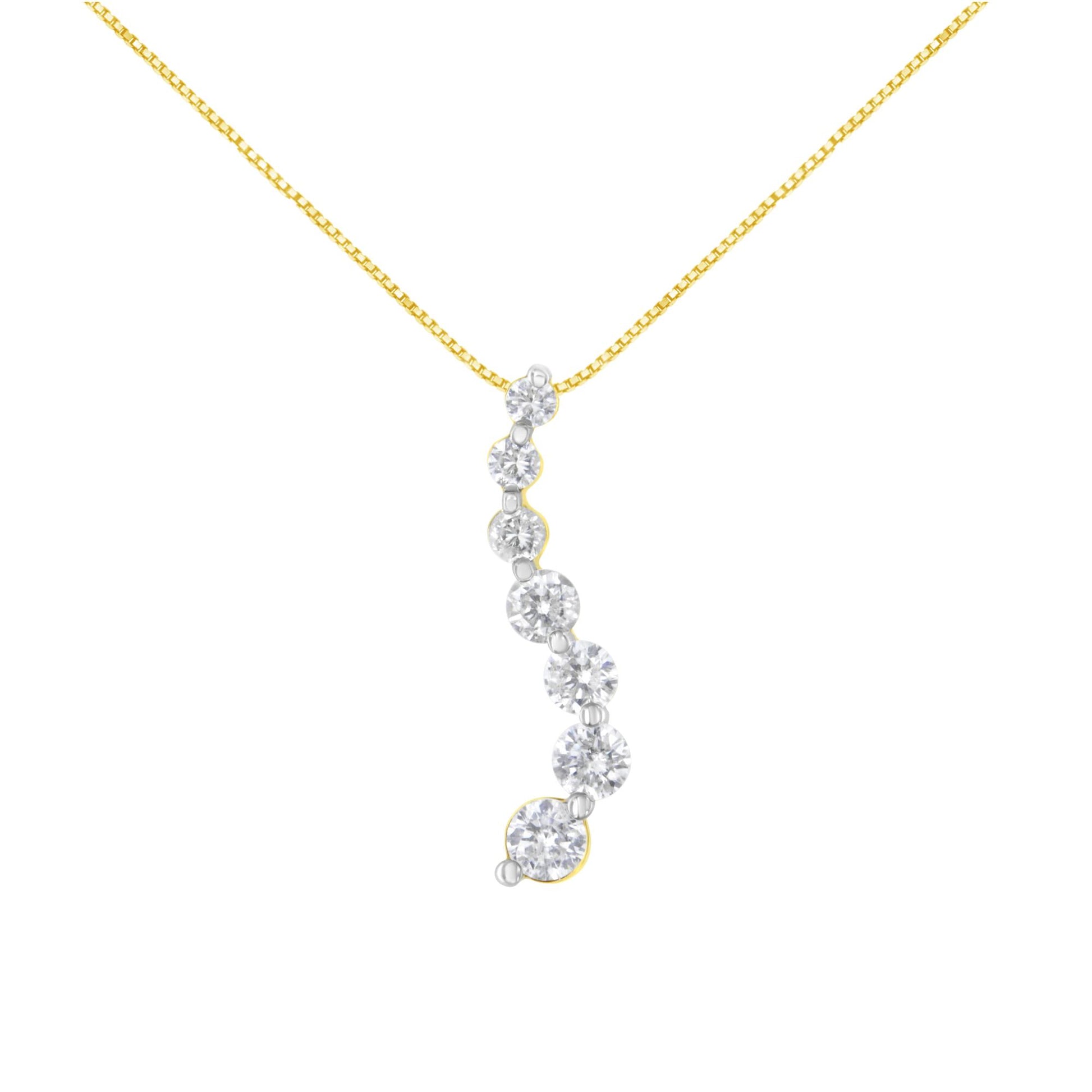 Front view of a yellow metal necklace with a pendant featuring a curved row of white round gemstones in prong settings.