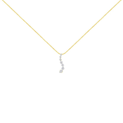 Front-facing shot of a yellow metal necklace with a vertical pendant featuring round white gemstones in prong settings.