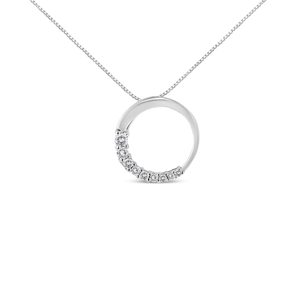 Front angle view of a white metal circular pendant necklace with half of the circle adorned with round white gemstones in prong settings.