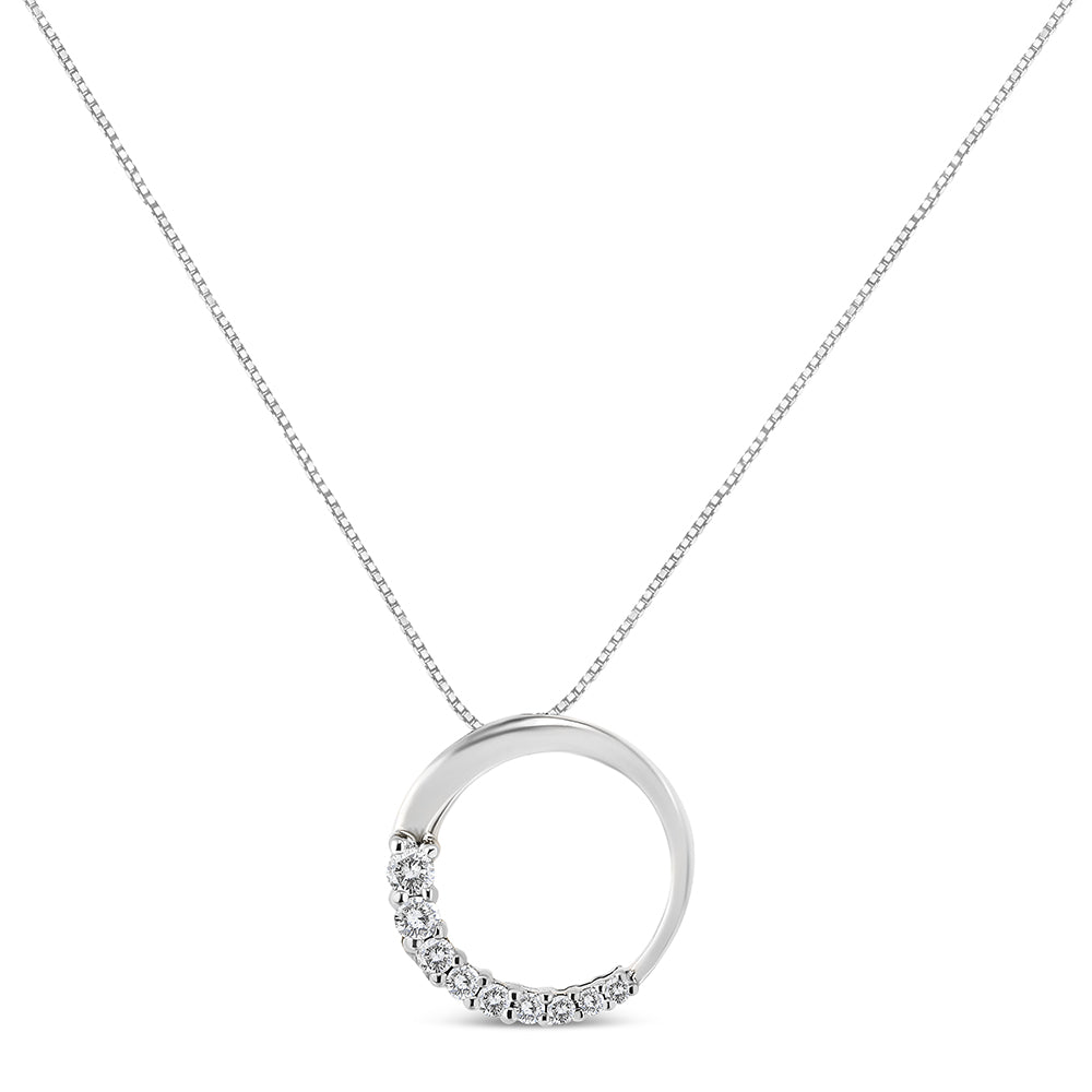 White metal necklace with a circular pendant featuring round white gemstones in prong settings along the lower left side, shown in a front-facing view.