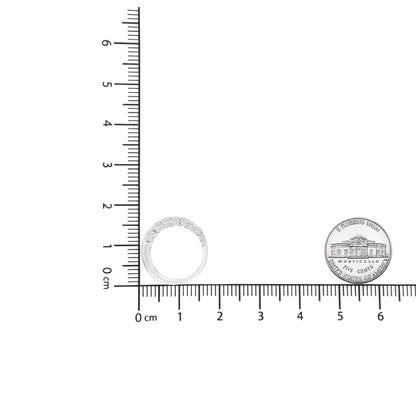 White metal necklace with nine round white gemstones in prong settings, shown from the front on a ruler for size reference.