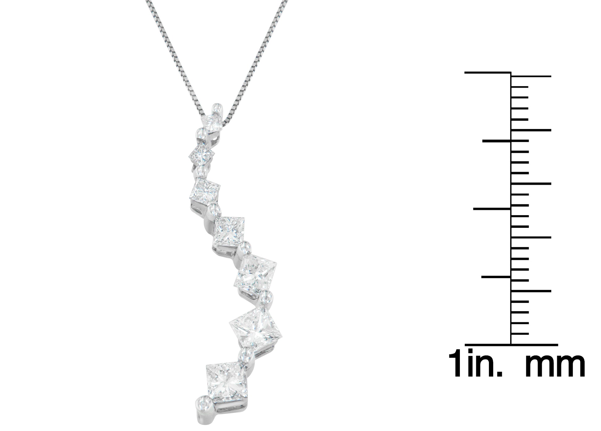 White metal necklace pendant with a curved design featuring prong-set princess shape white gemstones and channel-set baguette shape white gemstones, shown in a front angle next to a ruler for size reference.