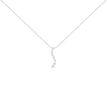 White metal necklace with a vertical curved pendant featuring round prong-set brownish gemstones, shown from front angle.
