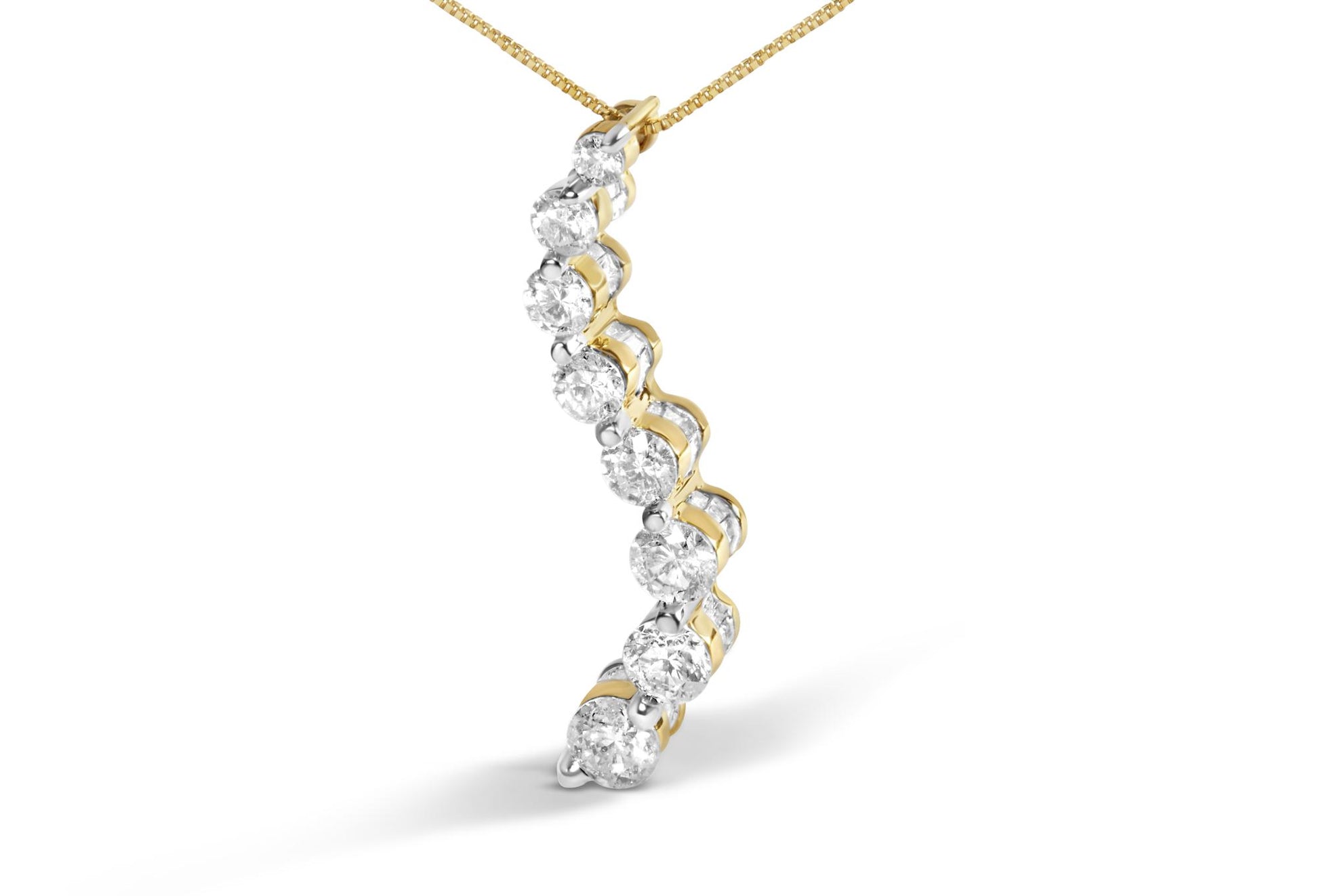 Yellow metal necklace pendant with alternating round white gemstones in prong settings and baguette white gemstones in channel settings, shown from a side angle.