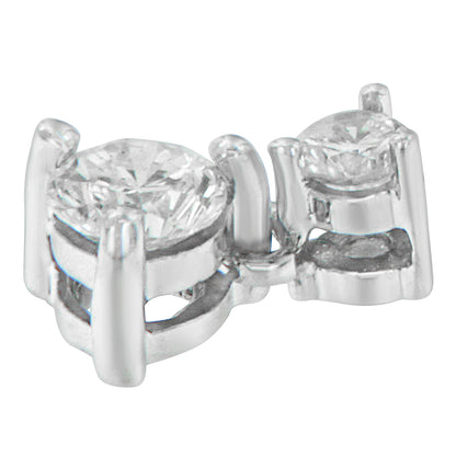 Close-up angled view of a white metal necklace pendant featuring two round white gemstones in prong settings.