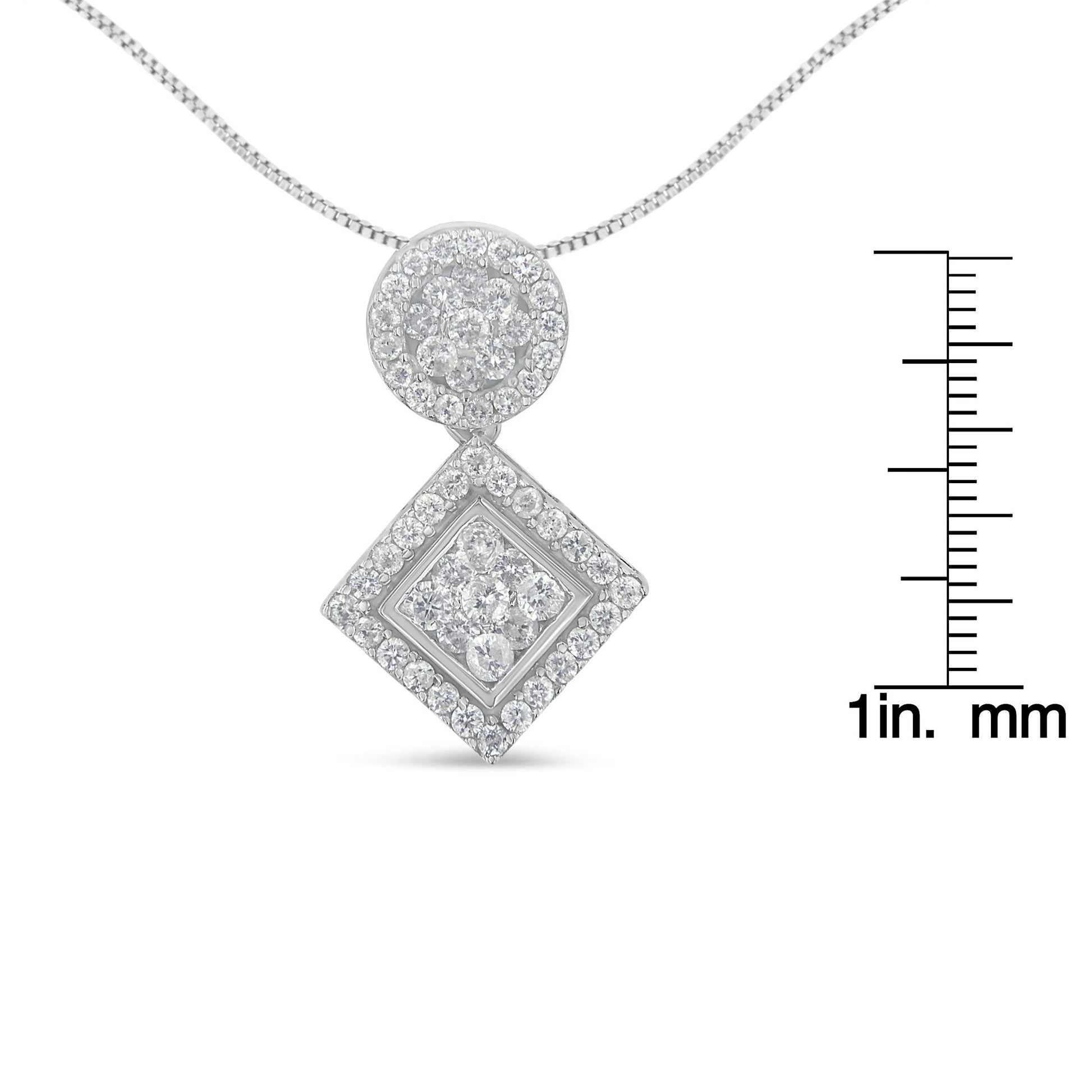 Front view of a white metal necklace with a pendant composed of a circular cluster of white round gemstones above a square cluster of white round gemstones, shown with a ruler for size reference.