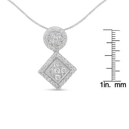 Front view of a white metal necklace with a pendant composed of a circular cluster of white round gemstones above a square cluster of white round gemstones, shown with a ruler for size reference.