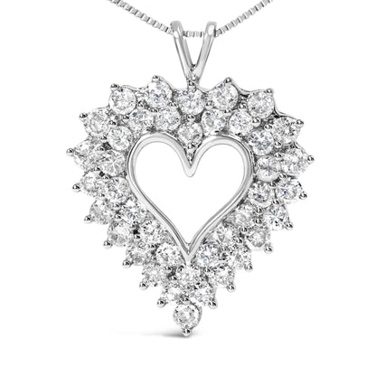 Front-facing view of a white metal heart-shaped necklace pendant adorned with round white gemstones in prong settings around the outline, with baguette white gemstones in channel settings forming the inner design.