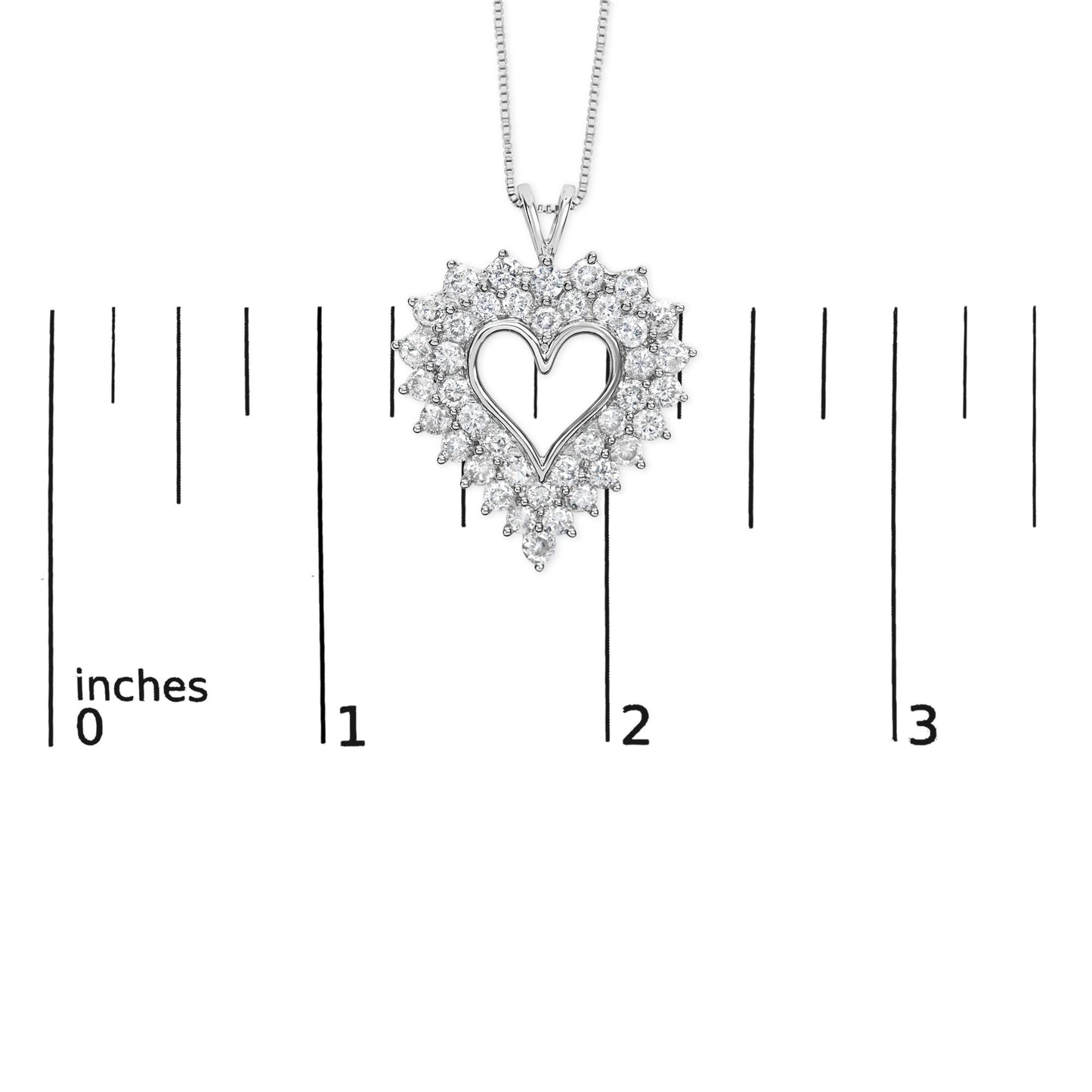 Close-up front view of a white heart-shaped necklace pendant with round and baguette white gemstones, displayed on a ruler for size reference.