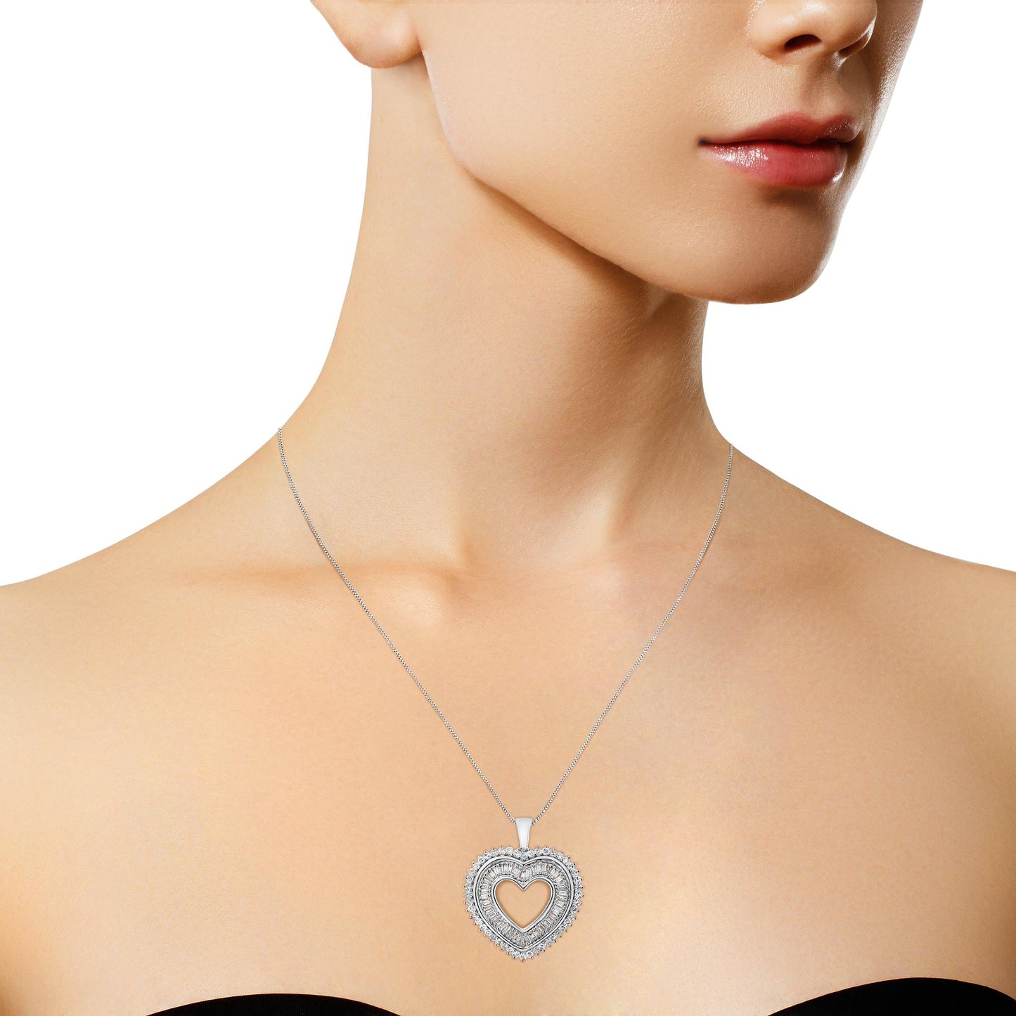 White metal necklace with a heart-shaped pendant adorned with white round and baguette-shaped gemstones, worn on a model, front-facing angle.