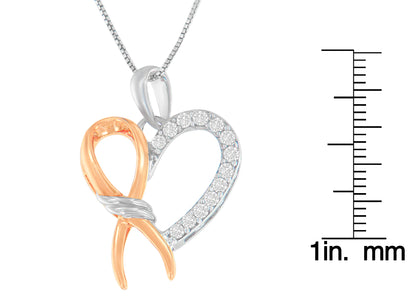 Two-toned necklace pendant in heart shape with one side featuring white gemstones in prong setting, shown in a close-up front angle, displayed next to a ruler for size reference.