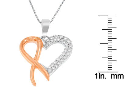 Close-up front angle of a yellow and white metal heart-shaped necklace pendant with round white gemstones on one side, shown next to a ruler for size reference.