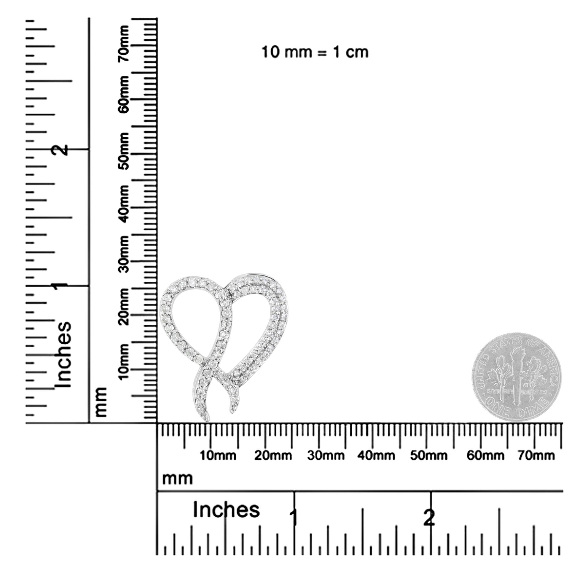 Close-up front angle of a white metal necklace pendant with two intertwined loops adorned with round prong-set white gemstones, shown on a ruler and scale for size reference.