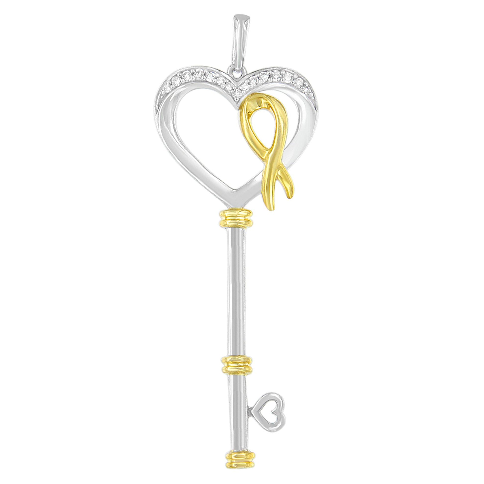 Two-toned key-shaped necklace pendant with a heart top adorned with round white gemstones, viewed from the front.