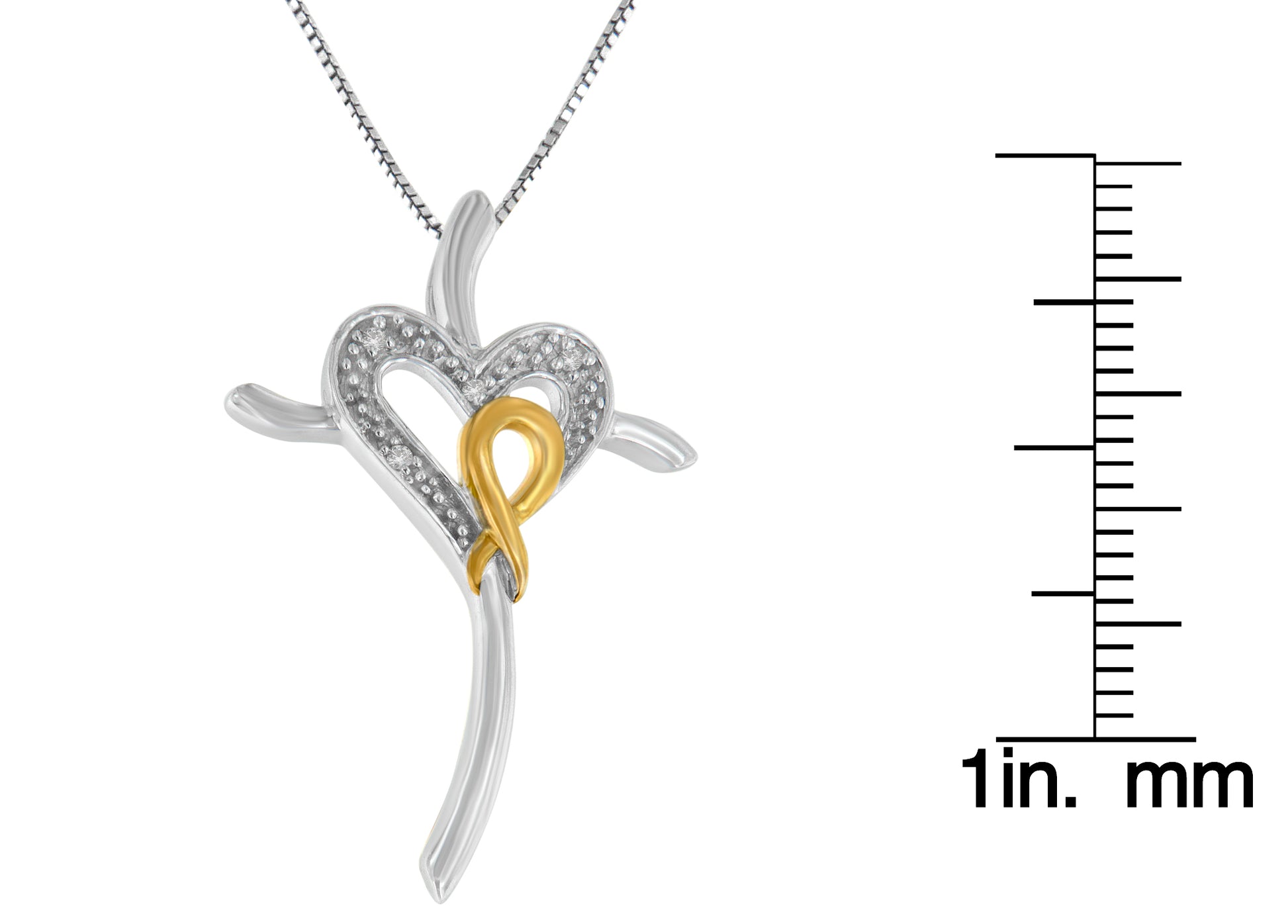 Close-up front angled view of a two-tone necklace pendant with a white metal heart shape partially encrusted with white gemstones and an intertwined yellow metal ribbon, shown with a ruler for size reference.