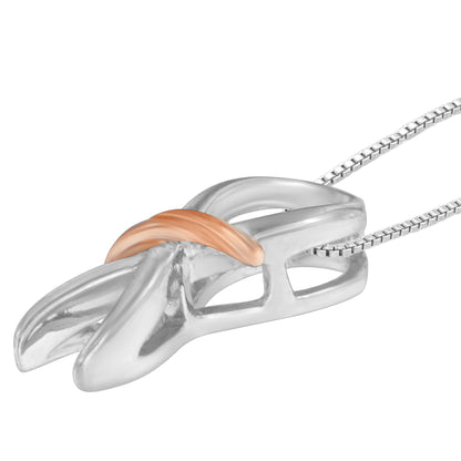 Close-up angled view of a two-toned necklace pendant with an abstract curved design, featuring a polished silver base and a smaller, smooth rose-colored accent piece.