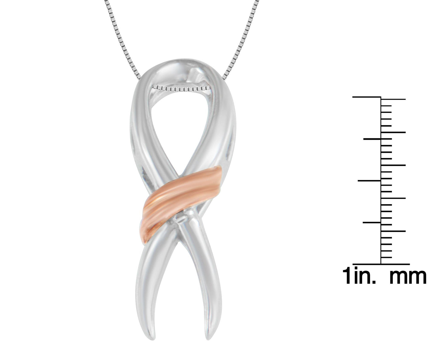 Front view of a two-toned necklace pendant shaped like a twisted ribbon with a scale for size reference on the right side.