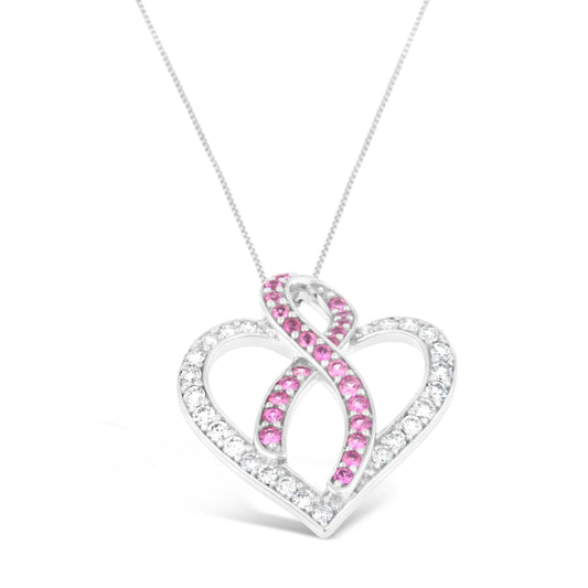 Close-up front angle of a white metal heart-shaped necklace pendant with white and pink round gemstones in prong settings.