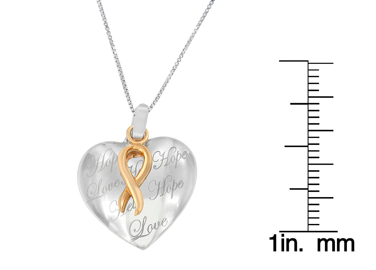 Two-toned heart-shaped necklace pendant with an infinity ribbon design in front, photographed from the front on a white background with a ruler for size reference.