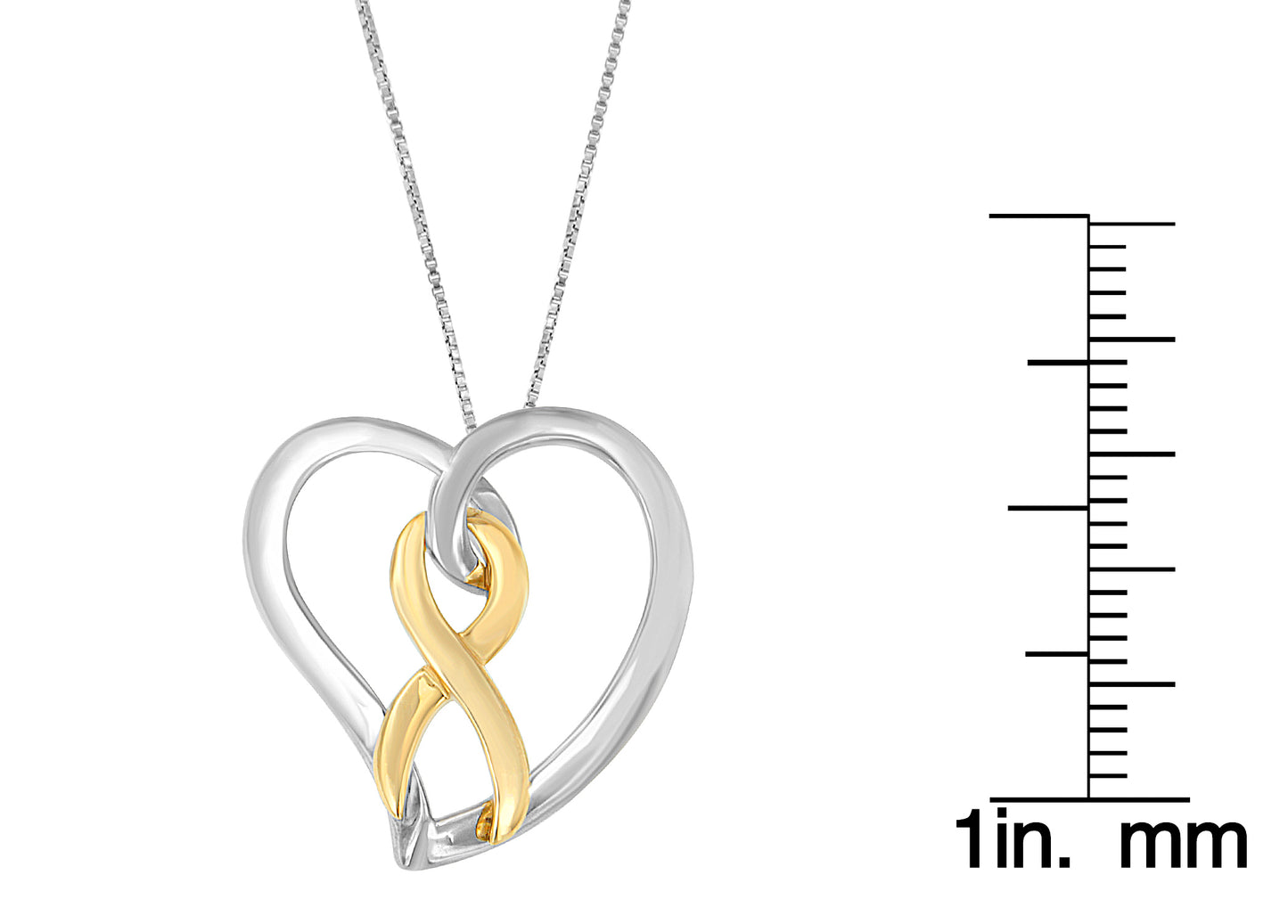 Two-toned heart-shaped necklace pendant shown from the front with attached chain, displayed next to a ruler for size reference.