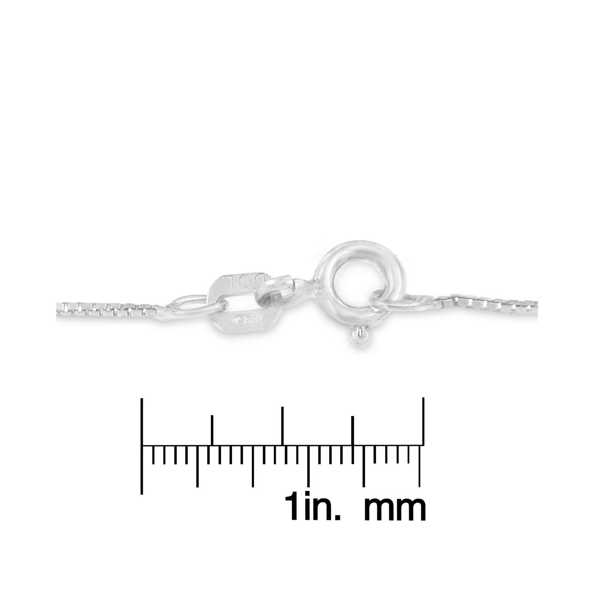 Close-up of tri-toned necklace clasp placed on a ruler for size reference, shot from the side.